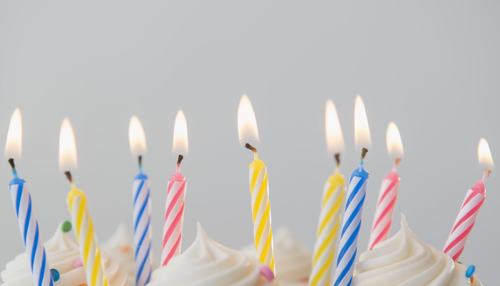Studio shot of birthday cake with lit candles