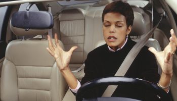 Frustrated woman driving car