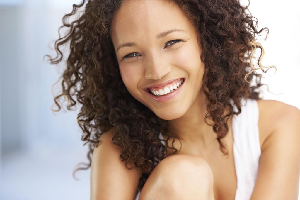 Naturally gorgeous young woman looking at you with a smile