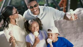 Parents and their two children eating ice cream cones