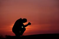Silhouette of Man Praying at Dusk