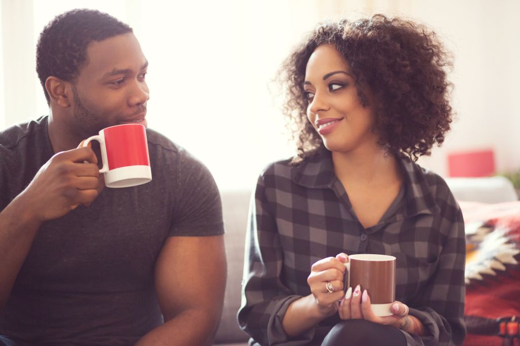 Afro american couple drinking coffee at home