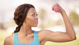 A beautiful african-american woman doing weight training outdoors
