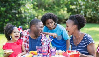 African American mixed race family at July 4th picnic