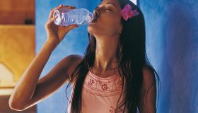 Thirsty Woman Drinking From a Bottle of Water