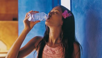 Thirsty Woman Drinking From a Bottle of Water