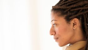 Woman with dreadlocks on white background