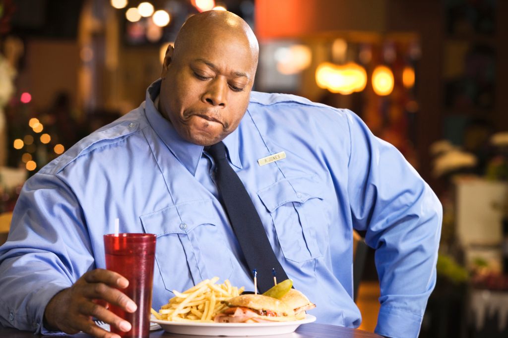 Black police officer eating unhealthy food