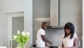 Couple preparing food in the kitchen, Cape Town, South Africa.