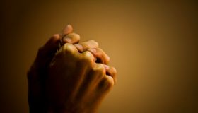 Close-up of a man's hand praying