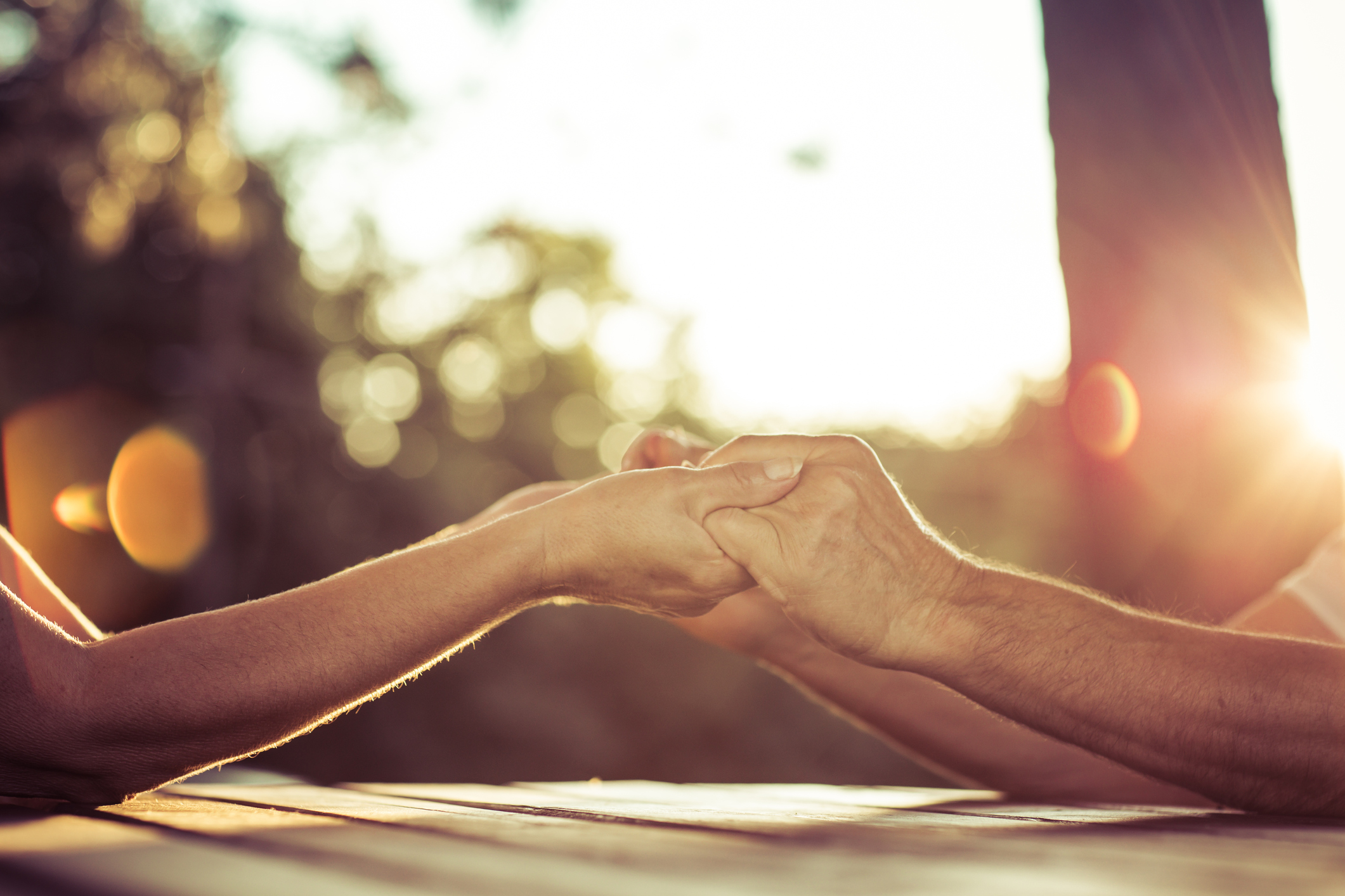 Senior couple on park bench enjoying sunset