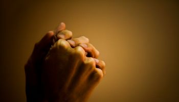 Close-up of a man's hand praying