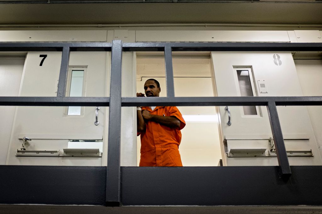 An inmate watches from his cell as DC Mayor Muriel Bowser tours DC Central Jail after announcing policy changes to support employment for inmates during and after incarceration in Washington...