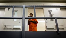 An inmate watches from his cell as DC Mayor Muriel Bowser tours DC Central Jail after announcing policy changes to support employment for inmates during and after incarceration in Washington...