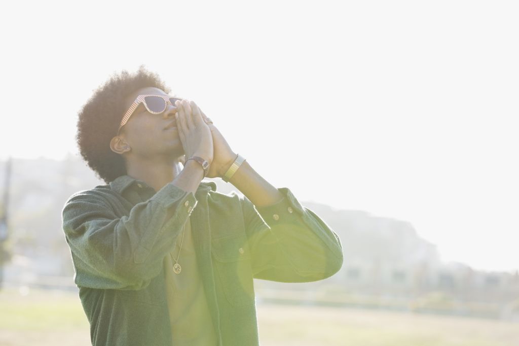 Man standing outdoors praying