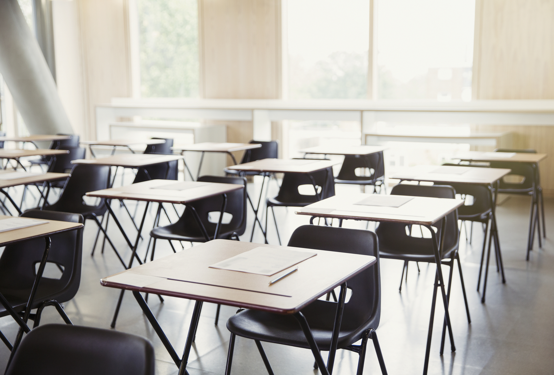 Tests on desks in empty classroom