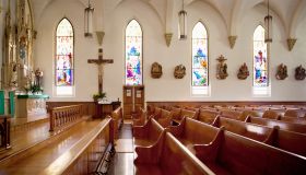 Pews and stained glass windows in church