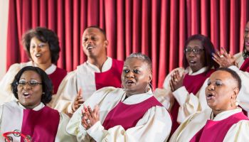Mature black women and men singing in church choir