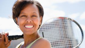 Black woman holding tennis racquet