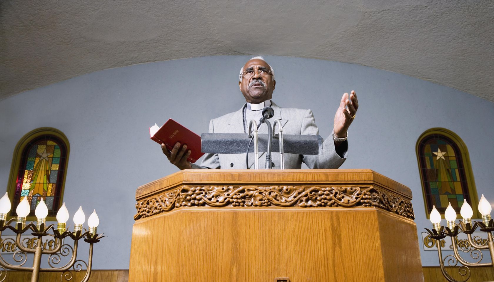 African American Reverend preaching in church