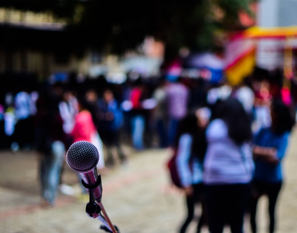 Close-Up Of Microphone Against Crowd During Music Concert