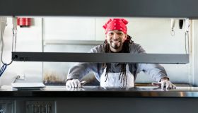 Mixed race man with dreadlocks in commercial kitchen