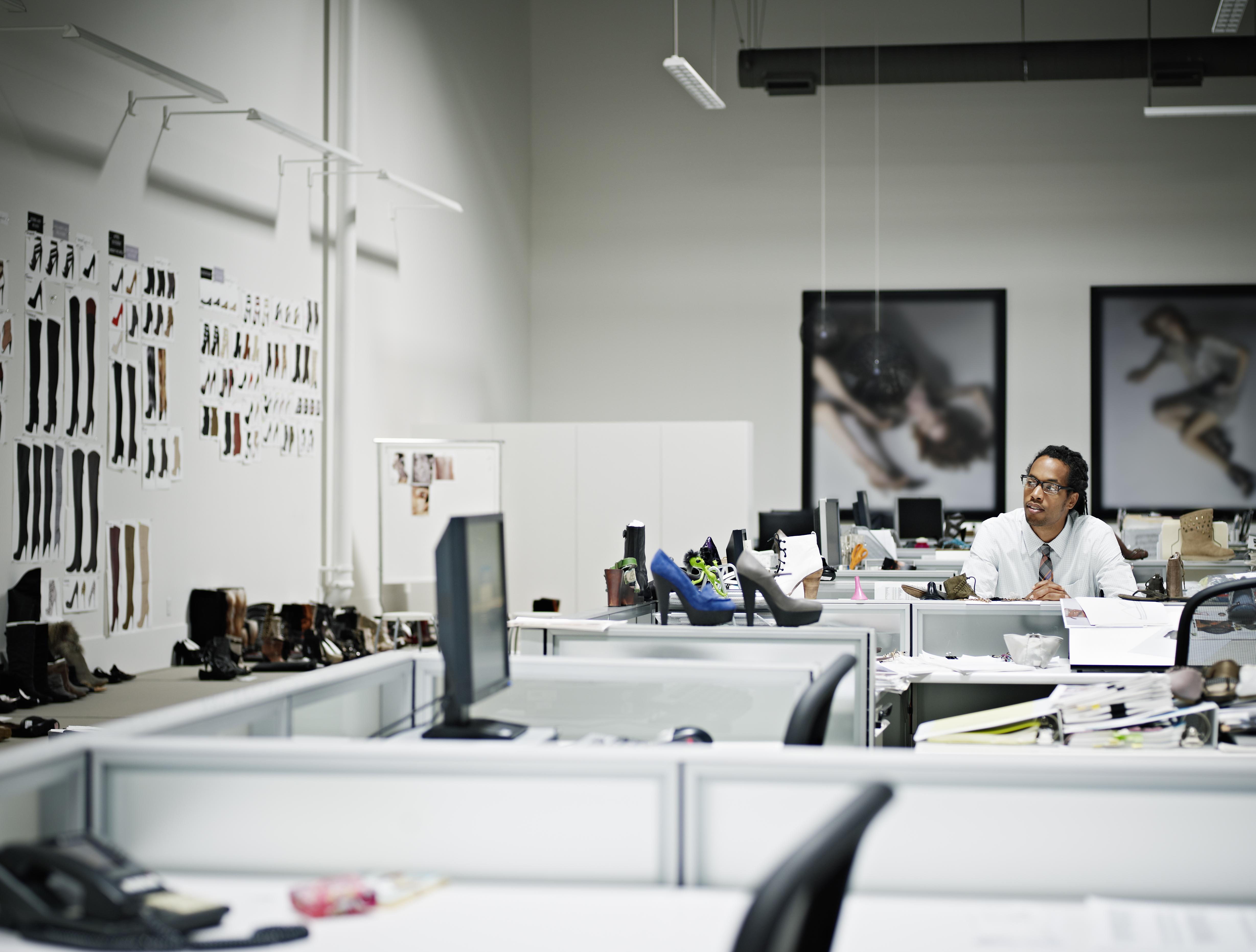 Designer sitting at desk looking at samples