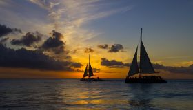 Silhouette of Two Sailboats on Ocean at Sunset