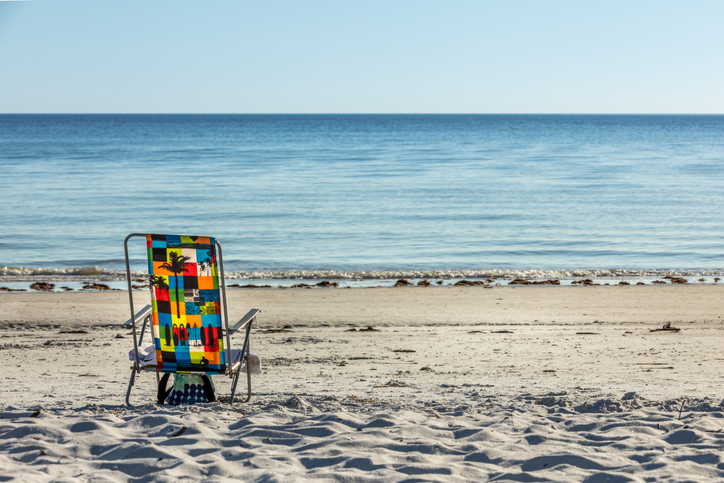 Deck Chair On Beach Against Clear Sky
