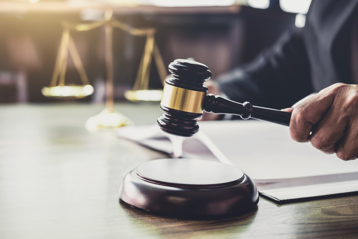 Cropped Image Of Lawyer Banging Gavel In Courthouse