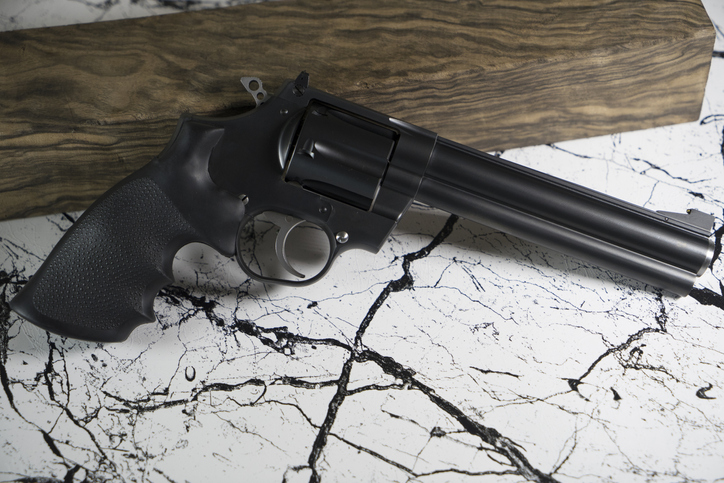 Long revolver with Bullet and marble background