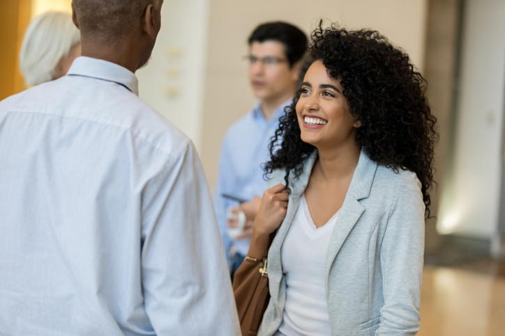 Cheerful businesswoman meets with hiring manager for interview