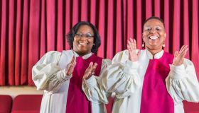 Two black women singing in church choir