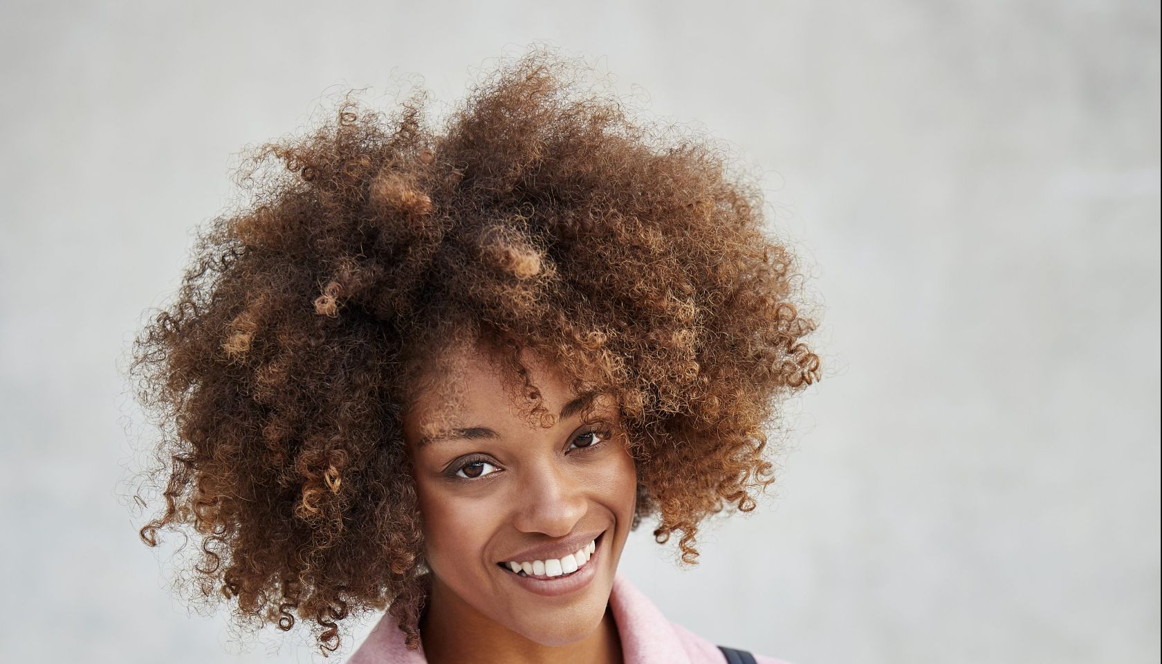 Happy woman text messaging through smart phone