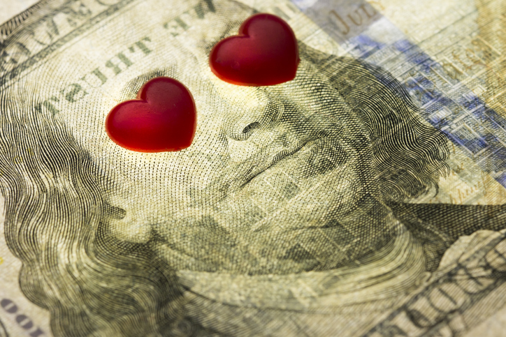 High Angle View Of Heart Shapes Over Paper Currency
