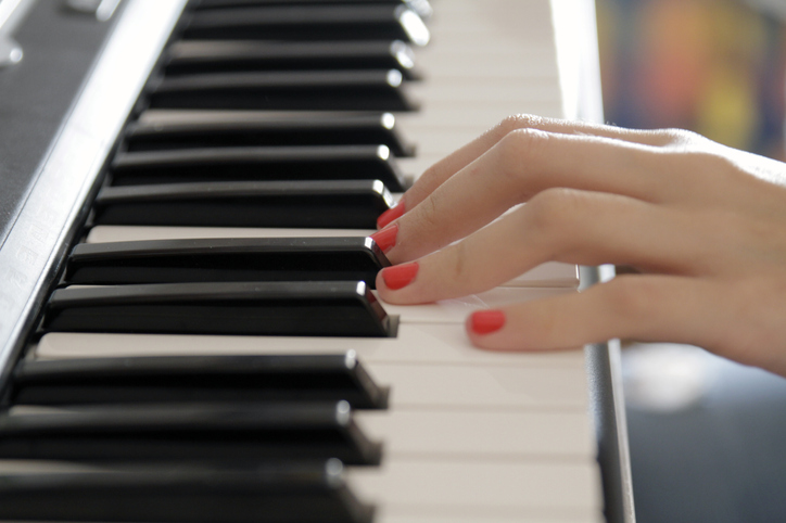 Close-up Of Woman Playing Piano