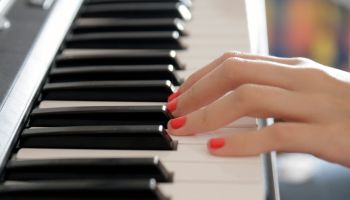 Close-up Of Woman Playing Piano