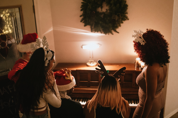 Generation Z Friends Christmas Party Singing At Piano