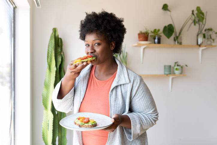 Woman eating healthy breakfast at home