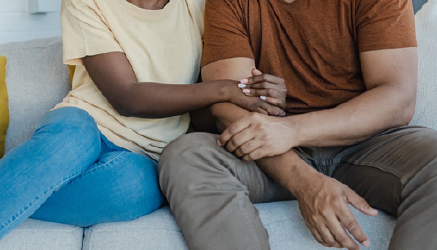 Portrait of a young African-American couple embracing at home