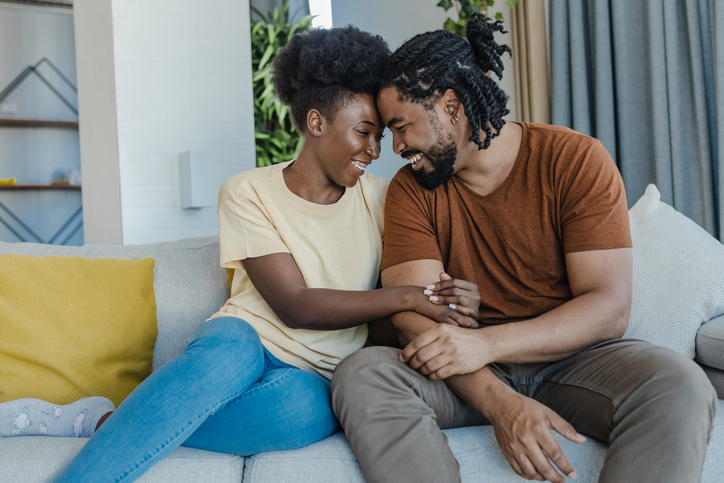 Portrait of a young African-American couple embracing at home