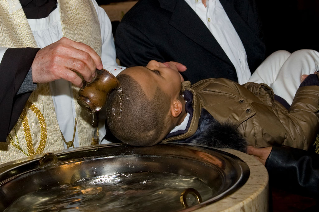 Baptism of an African boy. Legnano. Italy