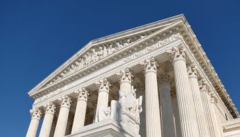 Low Angle View of the U.S. Supreme Court Building Against a Blue Sky