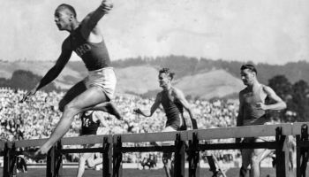 Berkeley, CA June 22, 1935 - Jesse Owens clears the last hurdle in the 220-yard hurdle race winning by seven feet over Glenn Hardin of Louisiana State (second from right) in the closing event of the National Collegiate Athletic Association meet. (Oakland