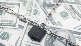 Lock security and chain on dollar banknotes background