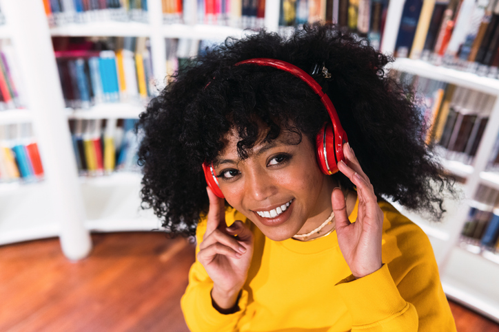 Portrait of cheerful African American woman in headphones